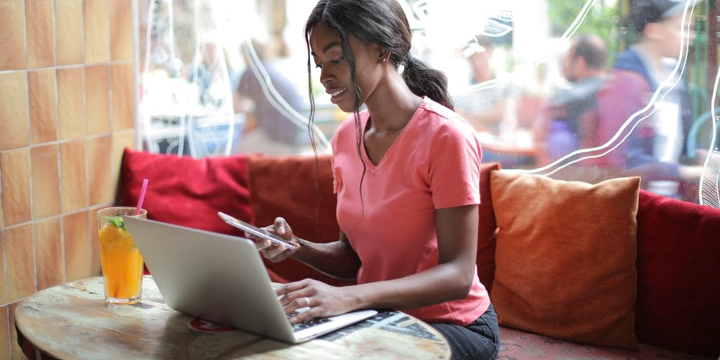 woman-in-pink-shirt-using-macbook-and-smartphone-3801741